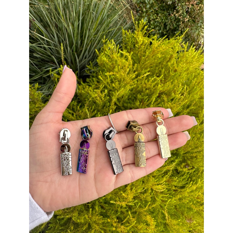 Candle zipper pulls