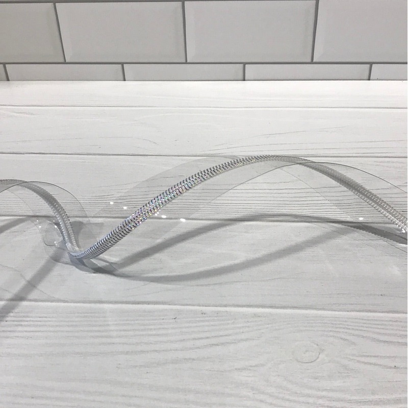 Clear vinyl zipper tape with white iridescent teeth